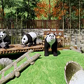 Scenic Panda Park Enclosure With Green Grass Bamboo Rocks And Wooden Fence