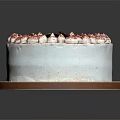 Delicious Decorated White Cream Cake With Purple Top Cream Flowers And Chocolate Decoration On Brown Tray