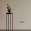 Red Vase With White And Green Flowers On Black Pedestal Against Light Colored Wall Poliform