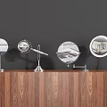 Round Vanity Mirrors With Metal Stands On Wooden Countertop Against Dark Wall