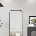Living Room With Black Framed Mirror Dark Cabinet Books Vase Green Plant And Wall Art