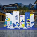 Outdoor Book Themed Installation With People Reading Stacked Books And Open