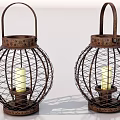 Two Rustic Metal Lanterns With Intricate Wire Designs And Lit Candles Inside