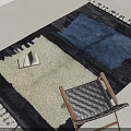 Leisure Chair with Woven Seat Wooden Frame Blue White Tasseled Rug and Stack of Books