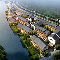 Aerial Planning View of Riverfront Traditional Building Complex with Green Trees and Roads