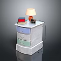 Colorful Drawer Nightstand With Table Lamp Stack Of Books And Alarm Clock
