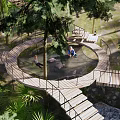 Scenic Park Landscape With Circular Wooden Walkway Trees Seating And Lush Greenery
