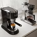 Stylish Black And Silver Coffee Machines On Kitchen Countertop With Window Blinds