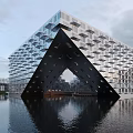 Unique Modern Architectural Building With Geometric Design Water Reflection Glass Facade Sky And Lake View