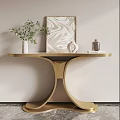 Golden Console Table with Artwork Vase with Plants and Decorative Jar Against Light Colored Wall