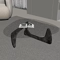 Modern Glass Coffee Table With Black Base Open Book And Small Cups On Gray Carpet