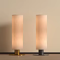 Two Modern Floor Lamps with Beige Shades Gold Black Bases Light Wall Wooden Floor