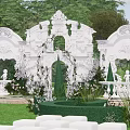 Elegant Garden Landscape Featuring White Arches Intricate Decorations Lush Green Lawn And Trimmed Hedges