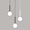 Three Modern Pendant Lights with Round Globe Shades and Metal Rods in Minimalist Interior