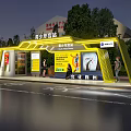 Youth Palace Station Bus Stop With Yellow Structure Advertisement Posters Pedestrians And Trees At Night