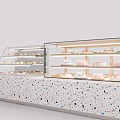 Elegant Glass Display Shelves with Terrazzo Countertop and Layered Pastries in Bakery Shop