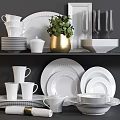 Modern White Dinnerware Set with Stacked Plates Cups Wine Glasses and Green Plant Decoration