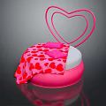 People Sitting on Pink Heart Shaped Sofa With Red Heart Pattern Blanket and Cushions