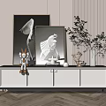Modern White TV Cabinet with Black Legs Decorated with Paintings Rabbit Figurine and Green Plant