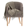 Gray Armchair With Black And White Herringbone Blanket And Wooden Legs