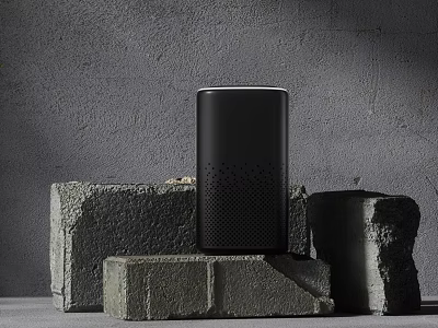 Sleek Black Wireless Speaker With Modern Design On Gray Stone Blocks And Gray Wall Background 3d model
