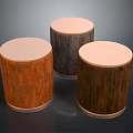 Three Cylindrical Wooden Stools With Round Tops And Different Wood Textures