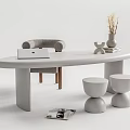 Modern White Oval Desk Featuring Laptop Vase Dried Flowers Gray Chair and Round Stools