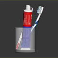 Essential Daily Household Essentials With Two Toothbrushes And Toothpaste Tube In Transparent Glass Cup