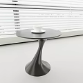 Modern Black Side Table with Spiral Curved Base and White Cup in Room with Window Blinds
