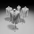 Three Classic Formal Suits On Mannequins With Brick Wall And Wooden Floor