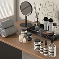 Stylish Bathroom Accessories Including Rolled Towels Mirror Aromatic Diffusers And Glass Bottles On Wooden Tray