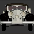 Vintage Convertible Car Featuring Silver Body Brown Top Classic Chrome Details and Round Headlights