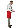 Man in White Shirt Black Tie and Red Apron Holding Device Against Gray Background