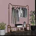 Golden Clothes Rack With Hanging Clothes Shoes Hats Storage Box Green Plants And Pink Wall