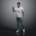 A Man Wearing White T-shirt And Green Graffiti Jeans Holding Phone Against Black Background