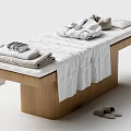 Comfortable Massage Bed with Wooden Frame White Sheets Folded Towels Blankets and Side Slippers