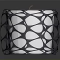 Black Intricate Cutout Candle Holder With White Candle And Modern Design
