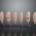 Six Fresh Sweet Potatoes Arranged With Reflections On Dark Background
