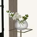 Transparent Glass Vase With White Flowers And Green Leaves On Gold Metal Table Near Window