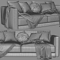 Cozy Two Seater Sofa with Plush Pillows and Checkered Blanket Accents