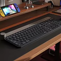 Wireless Computer Keyboard On Wooden Desk With Game Controller And Mouse