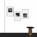 Three Black Framed Abstract Paintings on White Wall Featuring Geometric Patterns and Brown Round Table 3d model