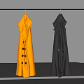 Two Stylish Yellow And Black Trench Coats Hanging On Gray Background
