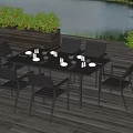 Outdoor Dining Set on Wooden Deck with Plants and Lake View