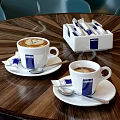 Lavazza Steaming Coffee Cups With Latte Art And Sachets On Wooden Table