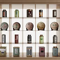 Wooden Display Shelf With Various Tea Cans And Round Tea Cakes Arrangement