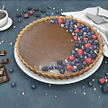 Fresh Chocolate Tart Topped With Blueberries Raspberries And Chocolate Pieces With Coffee Knife And Napkin