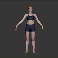 Woman Standing in Dark Sports Bra and Shorts with Arms Outstretched on Gray Background