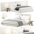 Modern Upholstered Double Bed With White Pillows Striped Blanket And Wooden Side Table