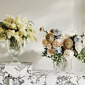 Decorative Glass Vases With Yellow Pink Blue Beige Flowers And Natural Foliage On Marble Table